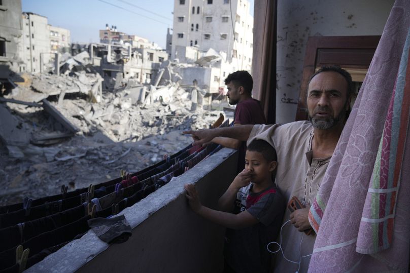 Palestinian points at destruction by the Israeli bombardment of the Gaza Strip in the Maghazi refugee camp, Friday, Nov. 3, 2023.