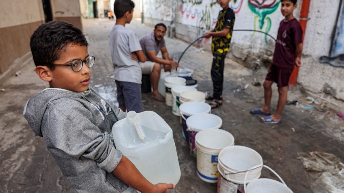 Um menino carrega um garrafão com água, em Gaza, 01 de novembro 2023