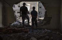 Palestinians look at the destruction after Israeli strikes on the Gaza Strip in Khan Younis on Saturday