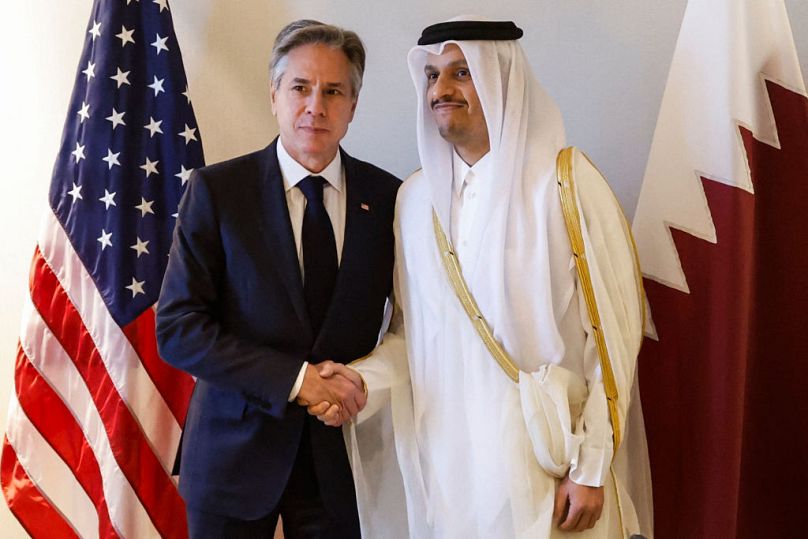 US Secretary of State Antony Blinken (L) shakes hands with Qatar's Prime Minister and Foreign Minister Mohammed bin Abdulrahman al-Thani on Saturday