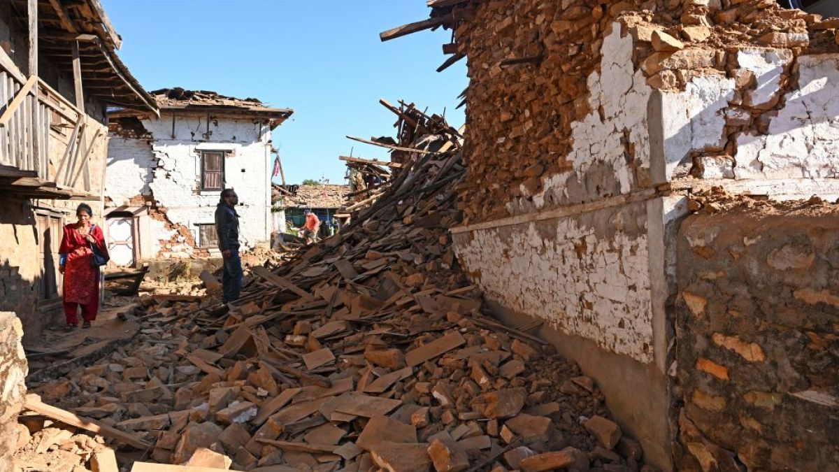  A man looks at damaged houses in the aftermath of an earthquake at Jajarkot district on Saturday