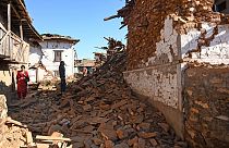  A man looks at damaged houses in the aftermath of an earthquake at Jajarkot district on Saturday