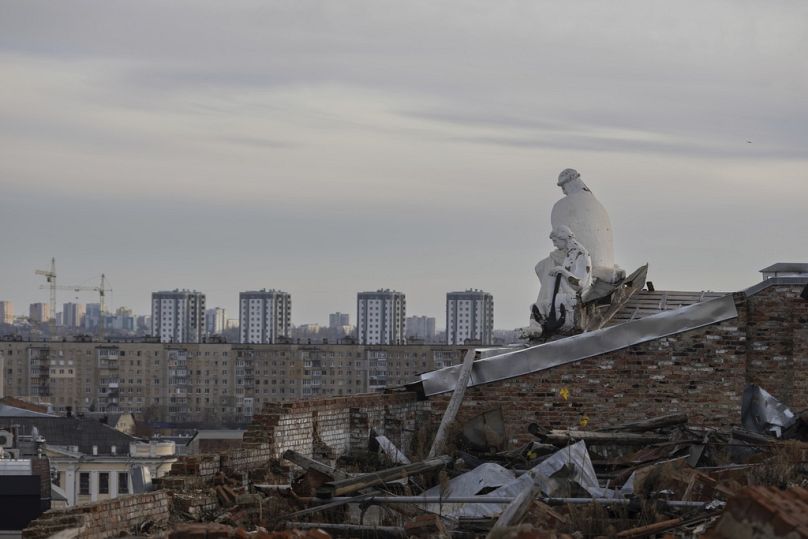 A statue is seen on the roof of a building which was damaged last year in Kharkiv, Ukraine, Friday, Nov. 3, 2023.