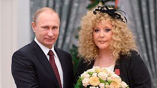 Russian President Vladimir Putin, left, and Russian pop singer Alla Pugacheva pose for a photo during an awards ceremony in Moscow's Kremlin in Moscow, Russia, in 2014