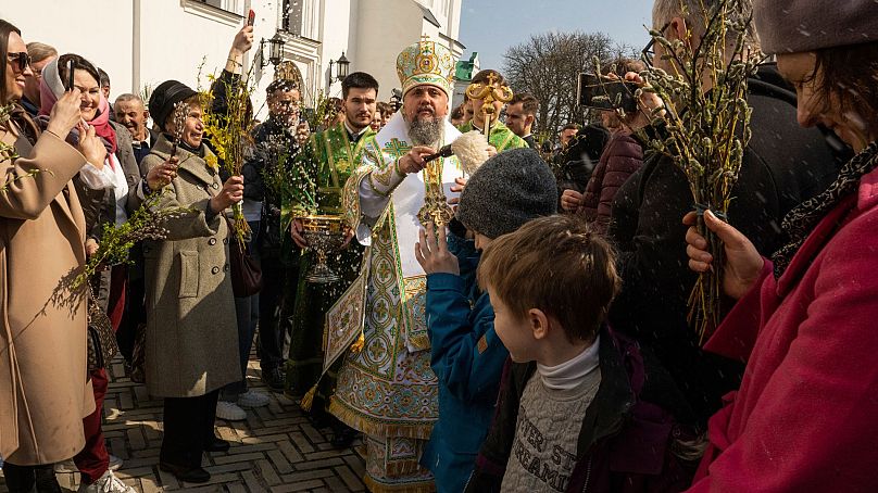 Metropolitan Epiphanius, head of the Orthodox Church of Ukraine, blesses worshipers celebrating Palm Sunday at Kyiv-Pechersk Lavra monastery on April 9, 2023.