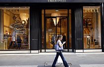 Picture showing a woman in front of an Emilio Pucci's boutique situated along Avenue Montaigne in Paris. 