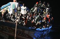 Migrants crowd a wooden boat as they are towed to the port in La Restinga on the Canary island of El Hierro on Saturday, Nov. 4, 2023. 