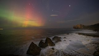 The Northern Lights appear over Four Sisters Rocks at South Shields, UK.