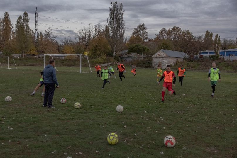 Young boys take part in a football training on a pitch, in the southern city of Kherson, on November 2, 2023