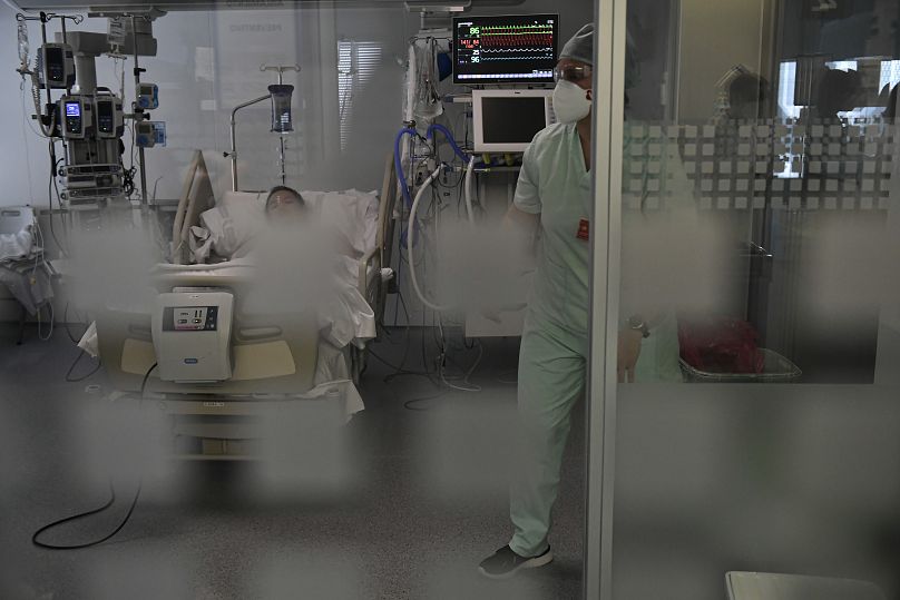 A medical staff member attends to a COVID-19 patient in the ICU department of the Hospital Universitario, in Pamplona, northern Spain.