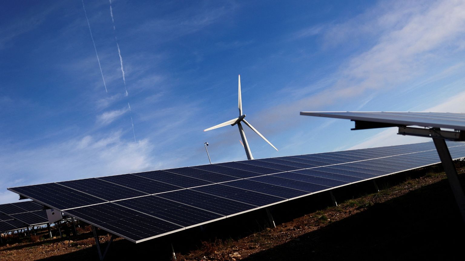 View of a hybrid power park with solar panels and wind turbines in Sabugal, Portugal.
