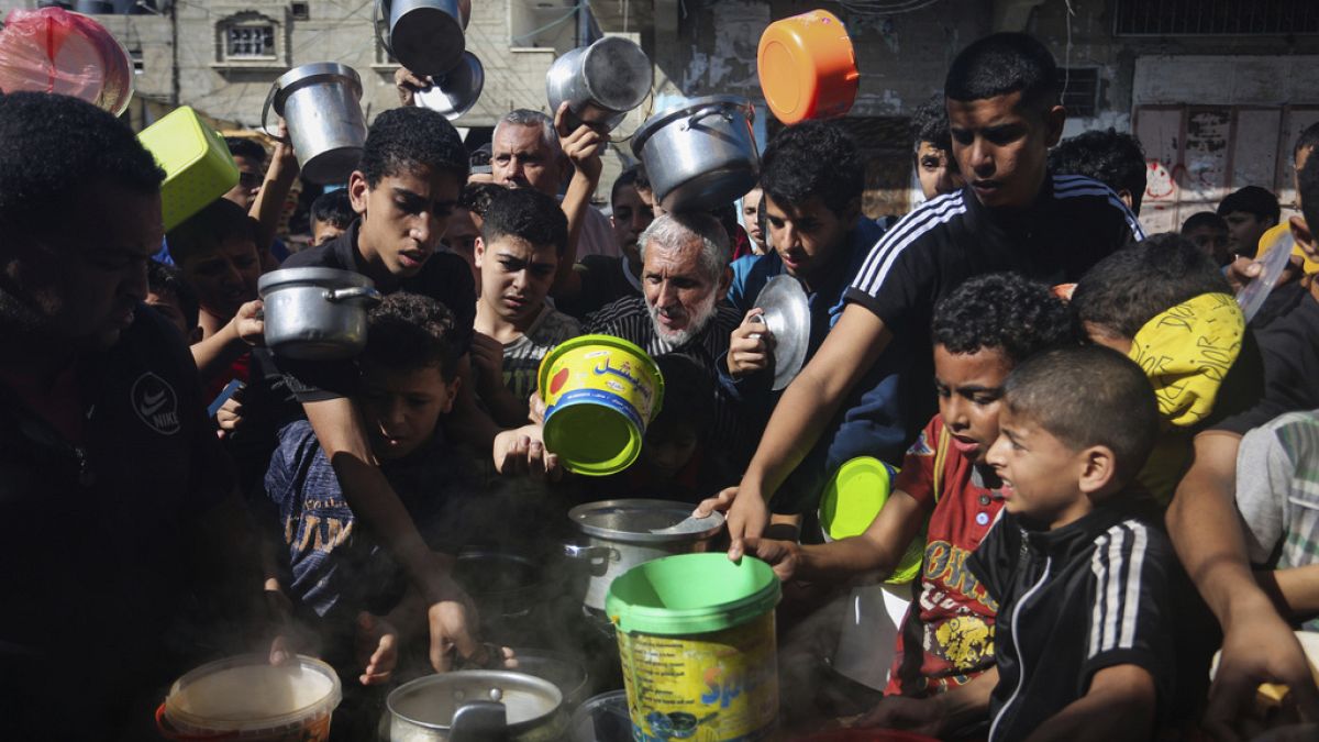 Palestinians crowded together as they wait for food distribution in Rafah, southern Gaza Strip, Wednesday, Nov. 8, 2023.