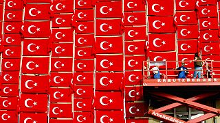 FILE - Workers attach flags with the national symbol of Turkey to the outside wall of the Kunsthalle in Kiel on Tuesday, August 19, 2003.