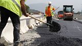 Employees are at work on a road construction under 39 degres Celcius during a heat wave the French Mediterranean island of Corsica, outside Ajaccio on June 21, 2023.