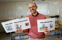 Nicolas Gaube (C), Life and Earth science (SVT) teacher, poses in his class at The Rene Cassin middle school in Agde, southern France, on November 6, 2023. 