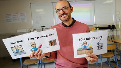 Nicolas Gaube (C), Life and Earth science (SVT) teacher, poses in his class at The Rene Cassin middle school in Agde, southern France, on November 6, 2023. 