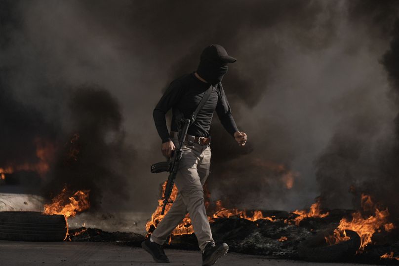 Palestinian military runs during clashes with Israeli forces in Jenin refugee camp in the West Bank, Thursday, Nov. 9, 2023.