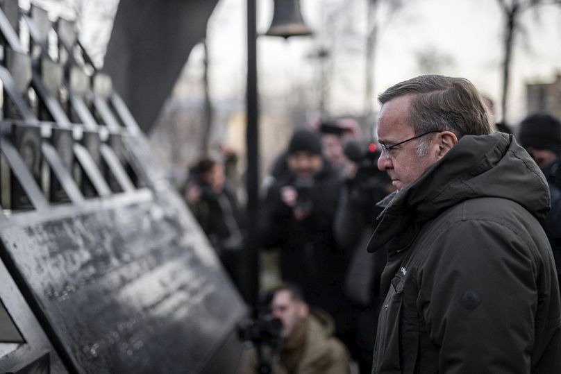 Germany's Defence Minister Boris Pistorius pays his respect at a memorial to people who died in clashes with security forces at the Independent Square in Kyiv, Ukraine