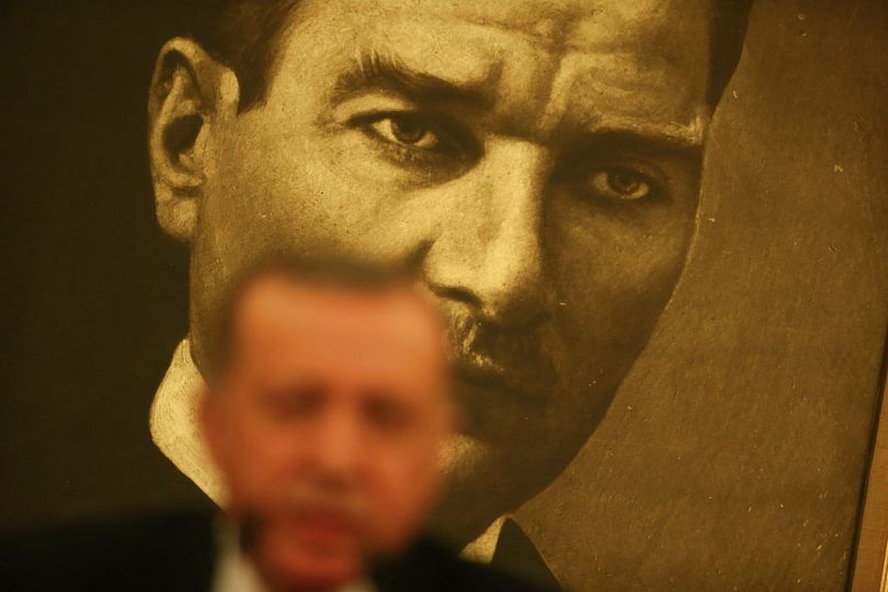 Backdropped by a poster of Mustafa Kemal Ataturk, the founder of modern Turkey, Turkey's President Recep Tayyip Erdogan talks to members of the media in Istanbul, April 2017