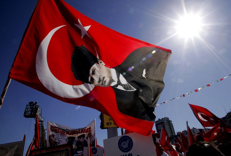 Demonstrators wave Turkish flags and a flag with the picture of modern Turkey's founder Ataturk during a pro-secular rally in Izmir, May 2007