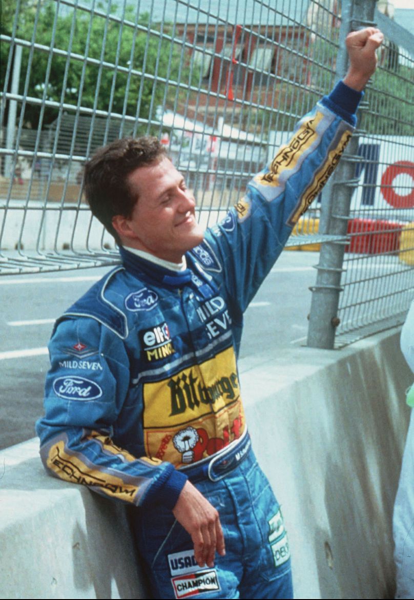 Schumacher celebrates winning the title from the side of the track, following the crash