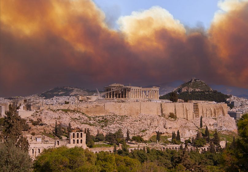 View of the Acropolis and the Parthenon against the background of smoke from fires in Athens, Greece