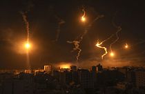 Flares fired by Israeli forces light up the night sky in Gaza City, Monday, Nov. 6, 2023.