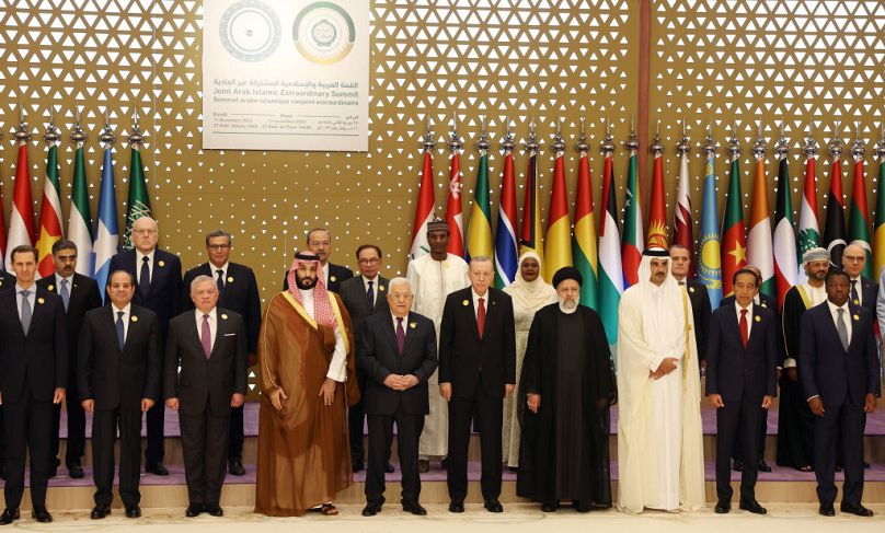 Turkish President Recep Tayyip Erdogan (5th R) poses for a family photo during the Extraordinary Joint Summit of the Organisation of Islamic Cooperation and the Arab League in