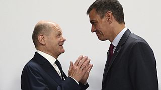 In this photo provided by the Spanish government, Germany's Chancellor Olaf Scholz, left, speaks with Spain's acting Prime Minister Pedro Sanchez at the Europe Summit in Grana