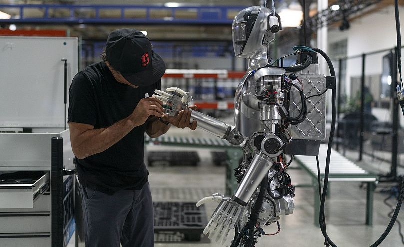 oel Carrasco performs maintenance on humanoid robot Figure 01 at Figure AI's test facility in Sunnyvale, California, Tuesday, October 3, 2023