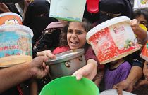 Palestinians line up for food during the ongoing Israeli bombardment of the Gaza Strip in Rafah on Monday, November 13, 2023. 