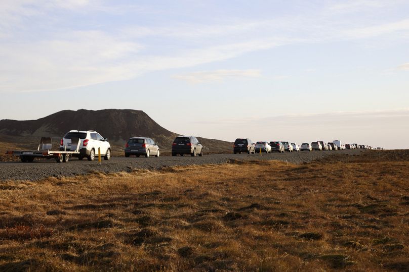 A line of cars queued on a road heading to the town of Grindavik, Iceland Monday Nov. 13