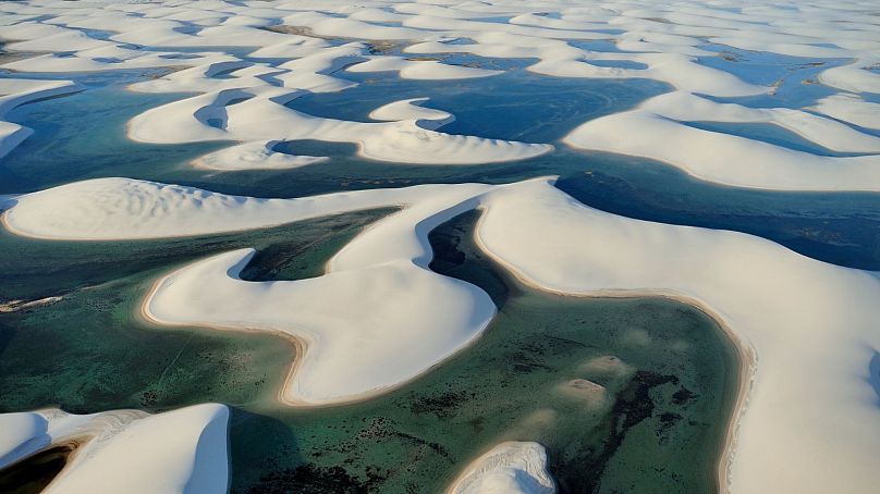 The otherworldly landscape of Lençóis Maranhenses is best enjoyed in July, when visitors can swim its blue lagoons.