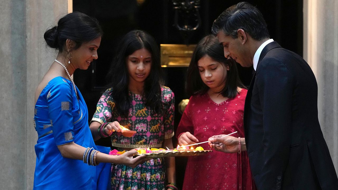 Britain's Prime Minister Rishi Sunak, right, lights the candles with his wife Akshata Murty and daughters to celebrate Diwali at 10 Downing Street in London.