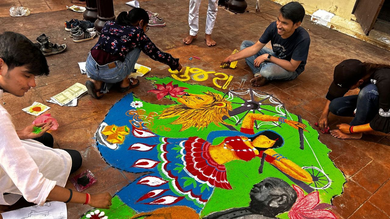 Students of Allahabad University create a Rangoli as part of celebrations to mark Diwali in Prayagraj, India, Thursday, Nov. 9, 2023 .