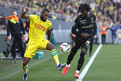 Nantes' Jean-Charles Castelletto, left, challenges for the ball with Reims' Josh Wilson-Esbrand during a match between Nantes and Reims, Sunday, Nov. 5, 2023.