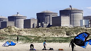 Kite surfers in front of the Gravelines nuclear plant near Dunkirk, northern France. April 18, 2015.
