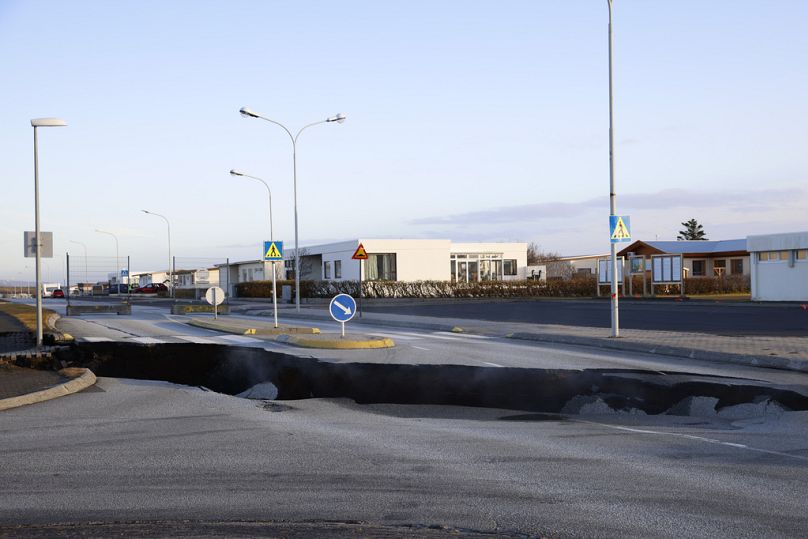 Steam rises from a fissure in a road near the town of Grindavik, Iceland Monday Nov. 13, 2023 following seismic activity.