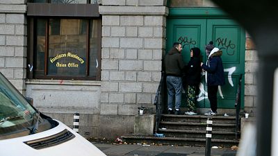 People gather near MQI addiction and homelessness charity in Dublin, Ireland, 10 November 2023