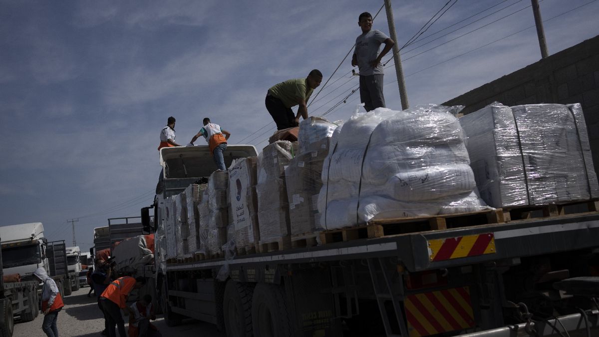 Trucks with humanitarian aid for the 'Gaza Strip enter from Egypt in Rafah on Oct. 21, 2023. 
