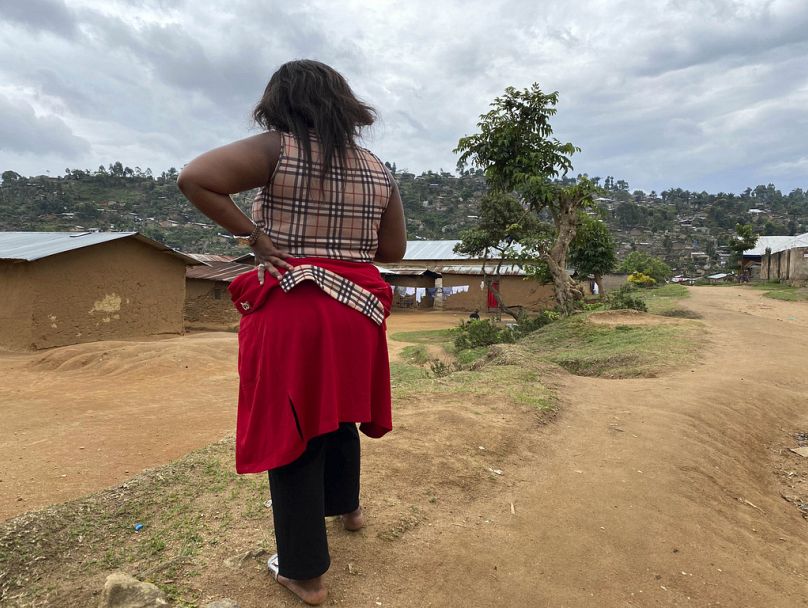 In this Thursday, March 18, 2021 file photo, Shekinah stands near her home in Beni, eastern Congo.