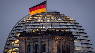 The German national flag waves on top of the Reichtstag building in Berlin, Germany, Thursday, Aug. 31, 2023. The Reichstag is the home of the German parliament Bundestag. (AP