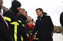 France's President Emmanuel Macron, shakes hands with members of rescue teams in Blendecques, northern France, Tuesday, Nov. 14, 2023. 