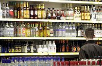  A young man stands in front of a shelve with hard liquor at a beverage market in Gelsenkirchen, western Germany, June 15, 2007. 
