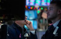 Traders work on the floor of the Dow Industrial Average at the New York Stock Exchange 