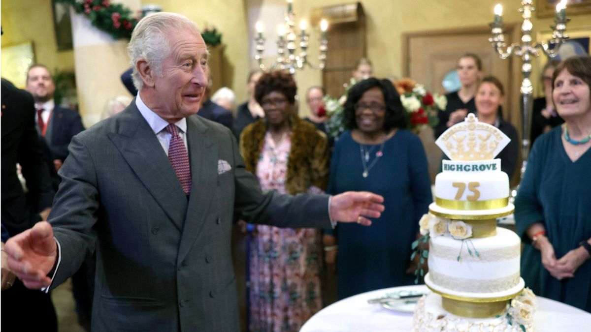 Britain's King Charles III stands by a cake as he attends his 75th birthday party at Highgrove Gardens in Tetbury, England, Monday, Nov. 13, 2023.