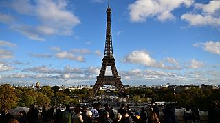 Tourists near the Eiffel Tower, Paris, November 2023.