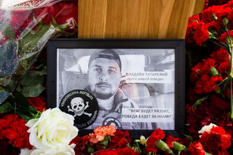 A framed photo of Vladlen Tatarsky at his grave at Troyekurovskoye cemetery in Moscow