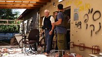 EU Foreign Policy Chief Josep Borrell (C) walks past debris during his visit to Kibbutz Beeri near the border with the Palestinian Gaza Strip on November 16, 2023.