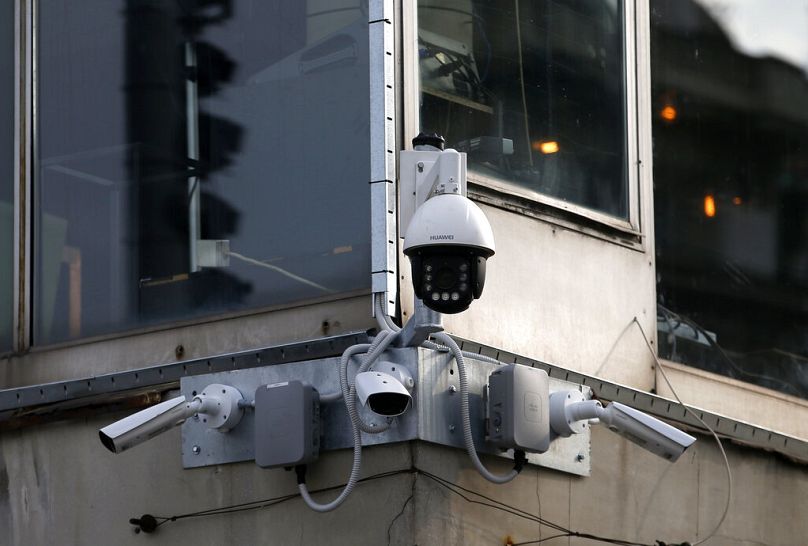 high-tech video cameras hang from an office building in downtown Belgrade, September 2019